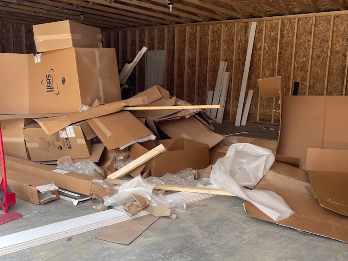 Pile of flattened cardboard and packaging for removal