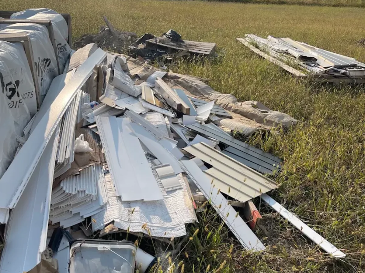 Construction siding and trim debris piled for cleanup