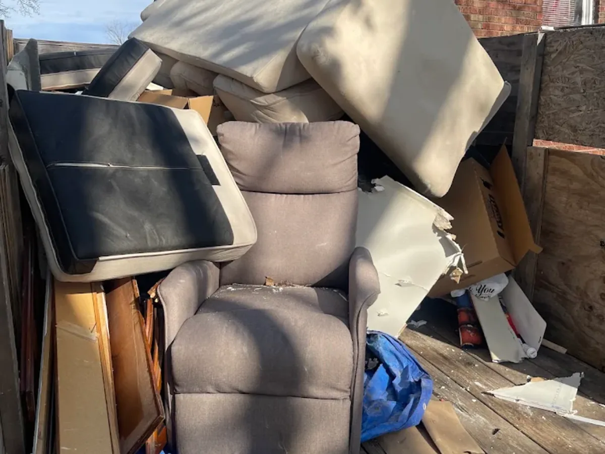 Furniture removal pile with recliner and mattresses